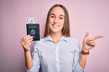 Tourist woman on vacation holding usa passport with dollars banknotes as a travel money very happy pointing with hand and finger to the side
