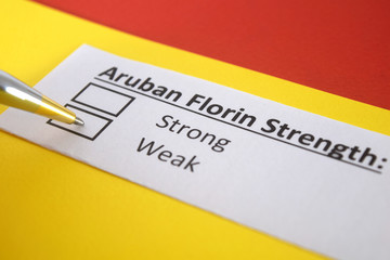 Obraz premium One person is answering question about strength of Aruban Florin.