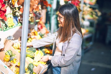 Young beautiful woman smiling happy and confident. Standing with smile on face at florist