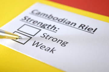 Obraz premium One person is answering question about strength of cambidian riel.