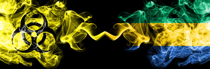 Quarantine in Gabon, Gabonese. Coronavirus COVID-19 lockdown. Smoky mystic flag of Gabon, Gabonese with biohazard symbol placed side by side.