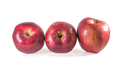 A set of three fresh red apples with drops isolated on white background