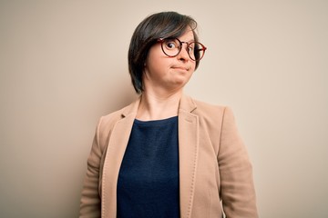 Young down syndrome business woman wearing glasses standing over isolated background smiling looking to the side and staring away thinking.