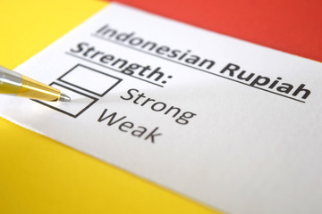 One person is answering question about strength of Indonesian Rupiah.
