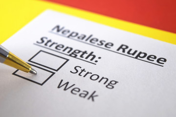 Obraz premium One person is answering question about strength of Nepalese Rupee currency.