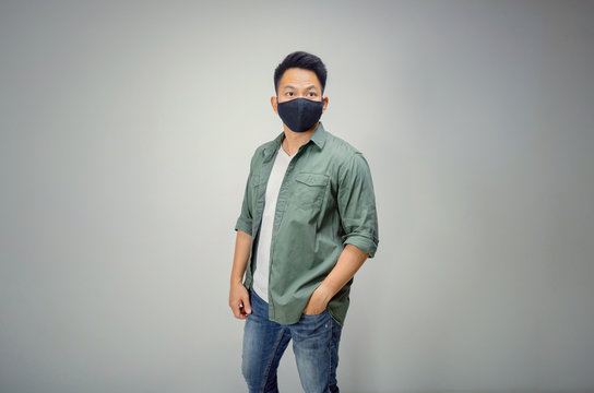 Vintage version of An Asian short hair man wears black mask.
