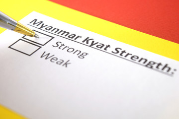 Fototapeta premium One person is answering question about strength of Myanmar Kyat.