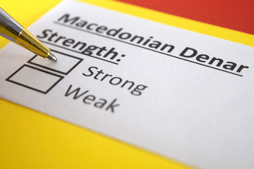 Obraz premium One person is answering question about strength of Macedonian Denar.