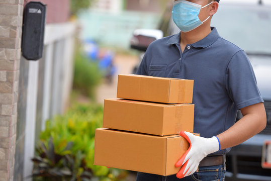 The Delivery Staff Put On A Protective Mask Of The Covid 19 Virus.