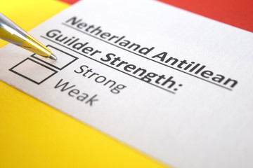 Obraz premium One person is answering question about strength of Netherland Antillean Guilder.