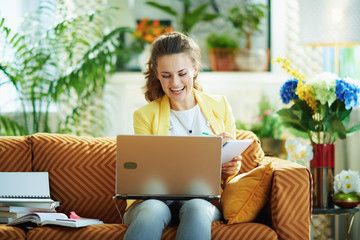 student in modern house in sunny day watching digital lessons