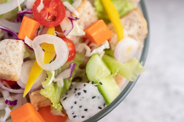 Vegetable and fruit salad on a white plate.