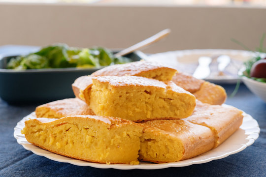 Close up view on cornbread corn pone in a white plate on the table covered with sesame seed organic vegetarian food vegan