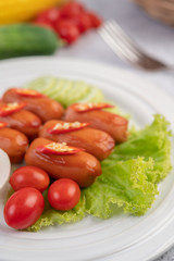 Sausage placed on a white plate.