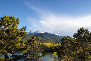 Fototapeta premium mountains with trees in denver colorado, clouds and sun