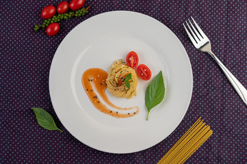 Stir-fried spaghetti beautifully arranged in a white plate.