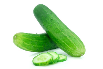 Close-up of Two whole fresh green cucumbers and slices isolated on white background.