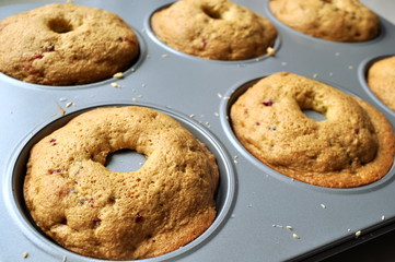 Recipe sequence - mini fruit sponge cakes - baking preparation.  Mixing eggs, yolks, flour and fruit into a liquid batter