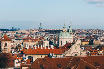 Obraz premium Scenic view of Prague city, over red roof from Vysehrad area at sunset lights. Streets and squares in Europe empty due to confinement during state of alarm for the Covid-19 coronavirus , Stay Home