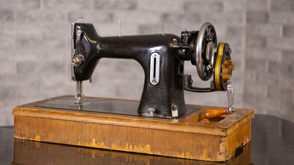 Close up of old manual sewing machine on table.