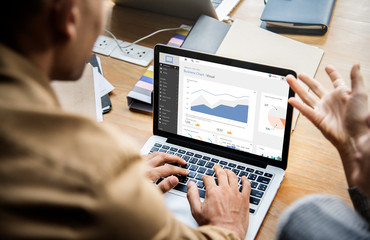 People working on a laptop in a meeting