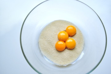 Recipe sequence - mini fruit sponge cakes - baking preparation.  Mixing eggs, yolks, flour and fruit into a liquid batter