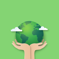 Hand holding earth.Paper cut of world environment day background.