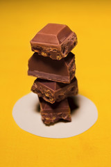 Brown chocolate filled with yellow cream and nuts