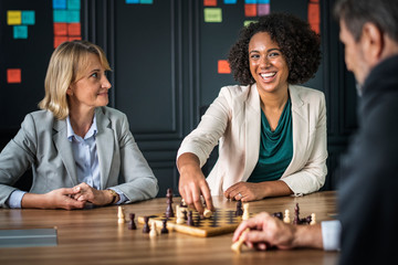 Buiness friends playing a game of chess