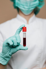 Nurse holding a blood test tube