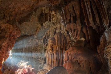 Sunlight shines  in the mouth of big stone cave