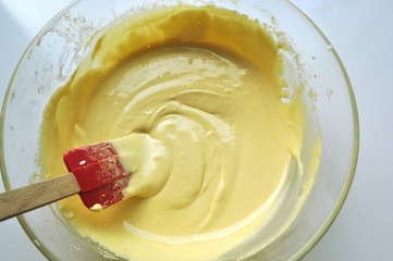 Recipe sequence - mini fruit sponge cakes - baking preparation.  Mixing eggs, yolks, flour and fruit into a liquid batter