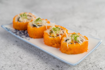 Sushi is beautifully arranged on the plate.