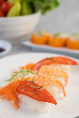Sushi is beautifully arranged on the plate.