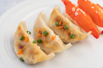Gyoza in a white dish.