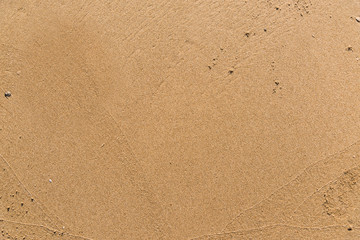Fototapeta na wymiar Flat sand on a beach textured backdrop
