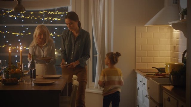 Multi Generations of Beautiful Women Preparing and Serving Dinner in Kitchen. Grandmother, Daughter and Cute Little Granddaughter Have Fun, Cooking Together, Talking, Sharing Secrets and Recipes