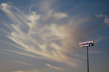 stadium lights against blue sky