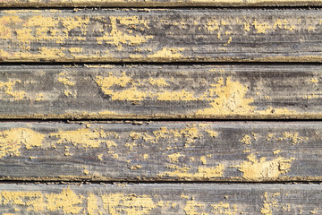 Yellow wooden peeling wall. Old painted boards. Textured Background.