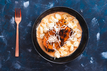 plant-based food, vegan tomato pesto potato gnocchi with oven roaste butternut squash pumpkin chunk and dairy-free cheese topping