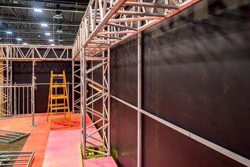 Construction work in the exhibition hall. Installation of metal frames for billboards. Installation...