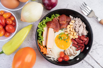 Vegetable salad with bread and boiled eggs in the pan.