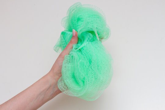 Green Nylon Washcloth In A Female Hand