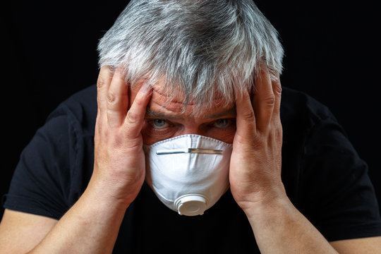 An elderly European man wears a protective mask against the virus. Pandemic Covid-19. - Powered by Adobe