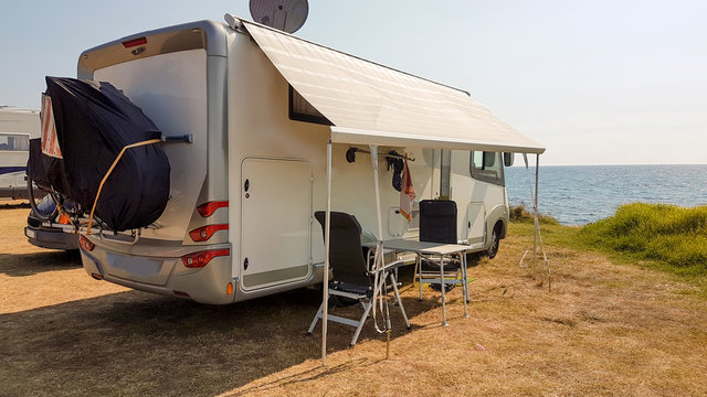 caravan car by the sea in autumn season cloudy blue ksy grass in preveza greece