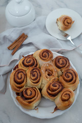 Cinnamon rolls with sugar frosting. With cinnamon sticks and spices