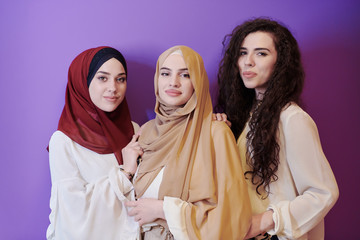 muslim women in fashionable dress isolated on purple