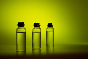 Three glass corked bottles filled with liquid. Background for science and medicine. Virus vaccine.