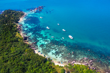 Aerial view of people swimming on the sea and beach on Gam Ghi Phu Quoc island in Thailand bay, Kien Giang, Vietnam.