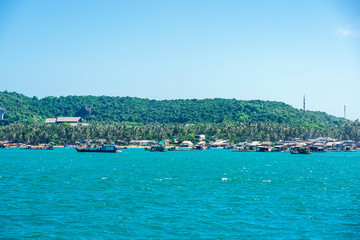 Fototapeta na wymiar Aerial view of white sand beach and boat on the blue lagoon aqua sea. Royalty high quality free stock image of Gam Ghi island in Phu Quoc, Kien Giang, Vietnam 